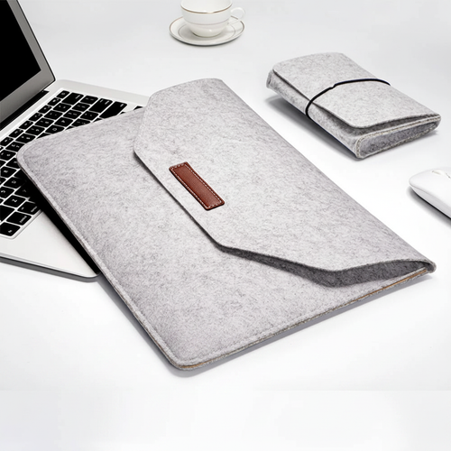 Wool Felt laptop sleeve placed beside laptop on workspace desk